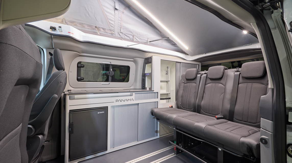 The Panama P-12 has grey flooring with grey upholstery.  Its rising roof is fully open.
