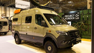 The Project Yonder Nomad 4X is a pale green with black trim.  It has a hammock on its roof.