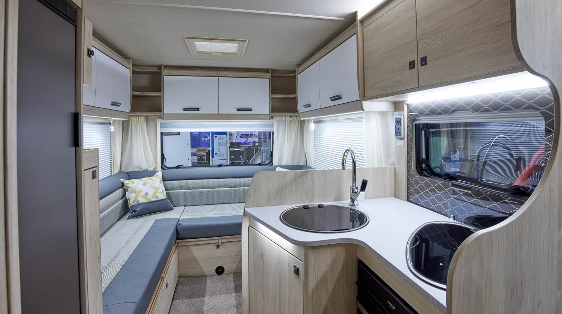Coachbuilt interior, grey and cream upholstery, wood and cream furniture