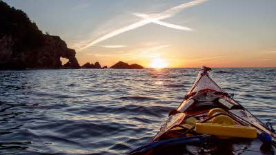 View of the sunset from a red canoe on Hele Bay, Ilfracombe