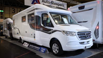 The Auto-Sleeper Burford has a white exterior with a cream inset and bronze/brown decals.