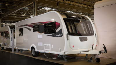 Elddis Crusader Aurora exterior is grey and white with black and red decals.  It has a large front window.