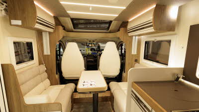 The Roller Team T-Line 750 has cream upholstery with matching furniture.  There's accent lighting.  The front seats are swivelled towards the rest of the van.  There is a table in the centre which can be extended.