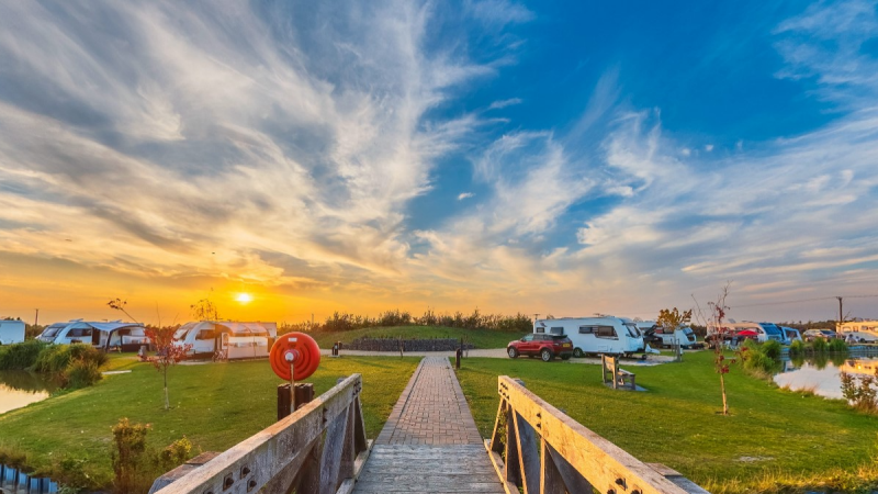 Picturesque sunset with caravans in the foreground at Fields End Water Caravan Park, Cambridgeshire