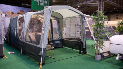 Campmaster 600 Limited edition has cream and brown canvas. The doors are open revealing the interior. There are two camping chairs inside the main tent