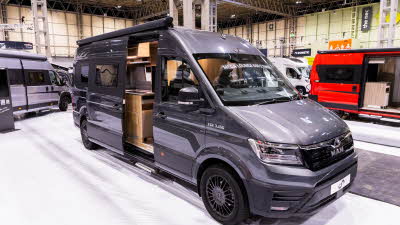 The Mega Mobil Mega Lounge 680 S Twin is grey.  Its sliding door is open.